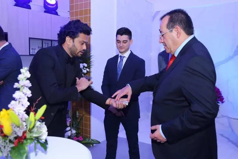 Close-up magician performing a card trick for guests at a corporate event